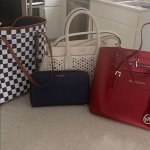 Three handbags and 1 wallet .
